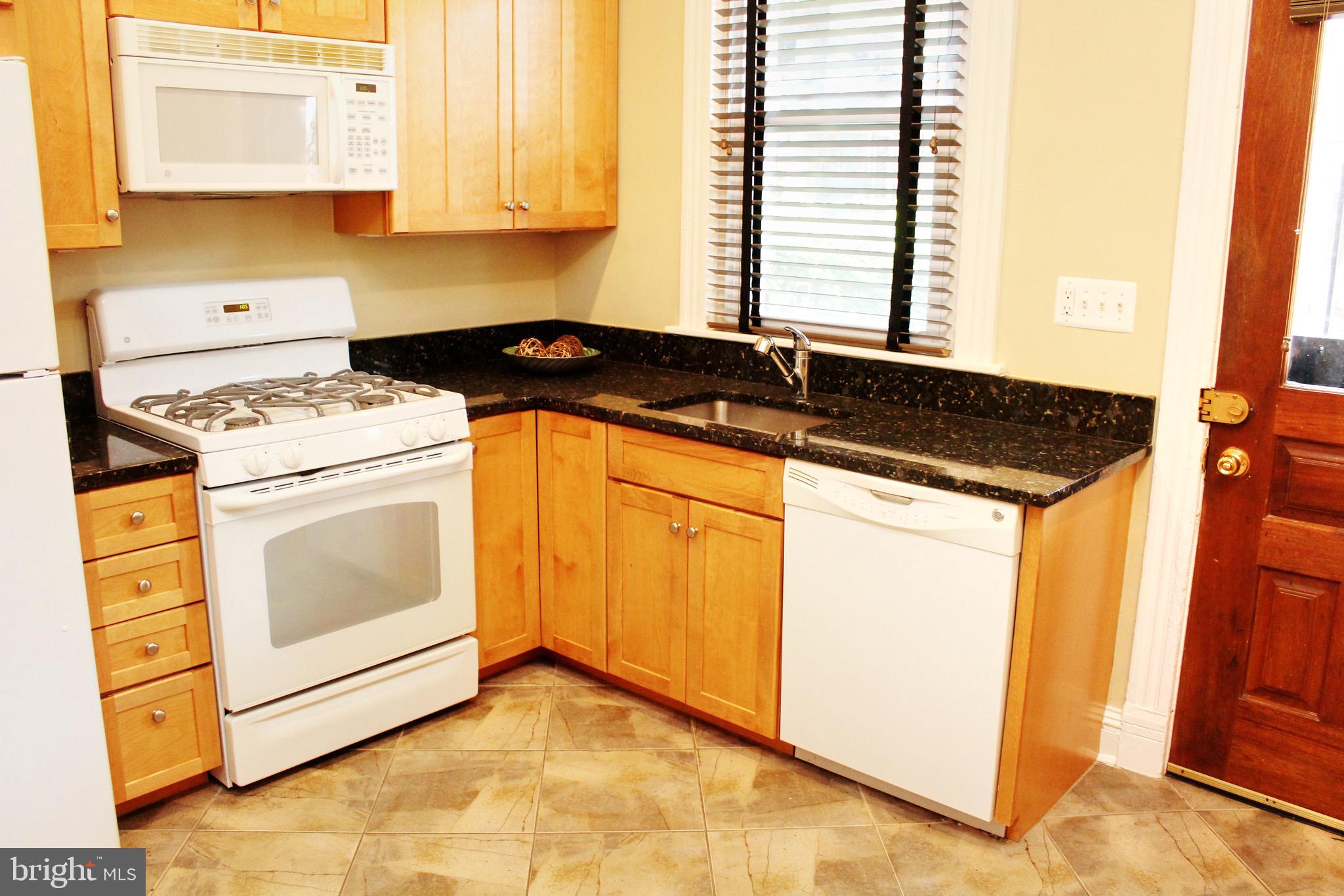 1731 Riggs Place Northwest, Unit 2 Washington, DC 20009 - Photo 23 of 24 a kitchen with a stove a sink and a microwave
