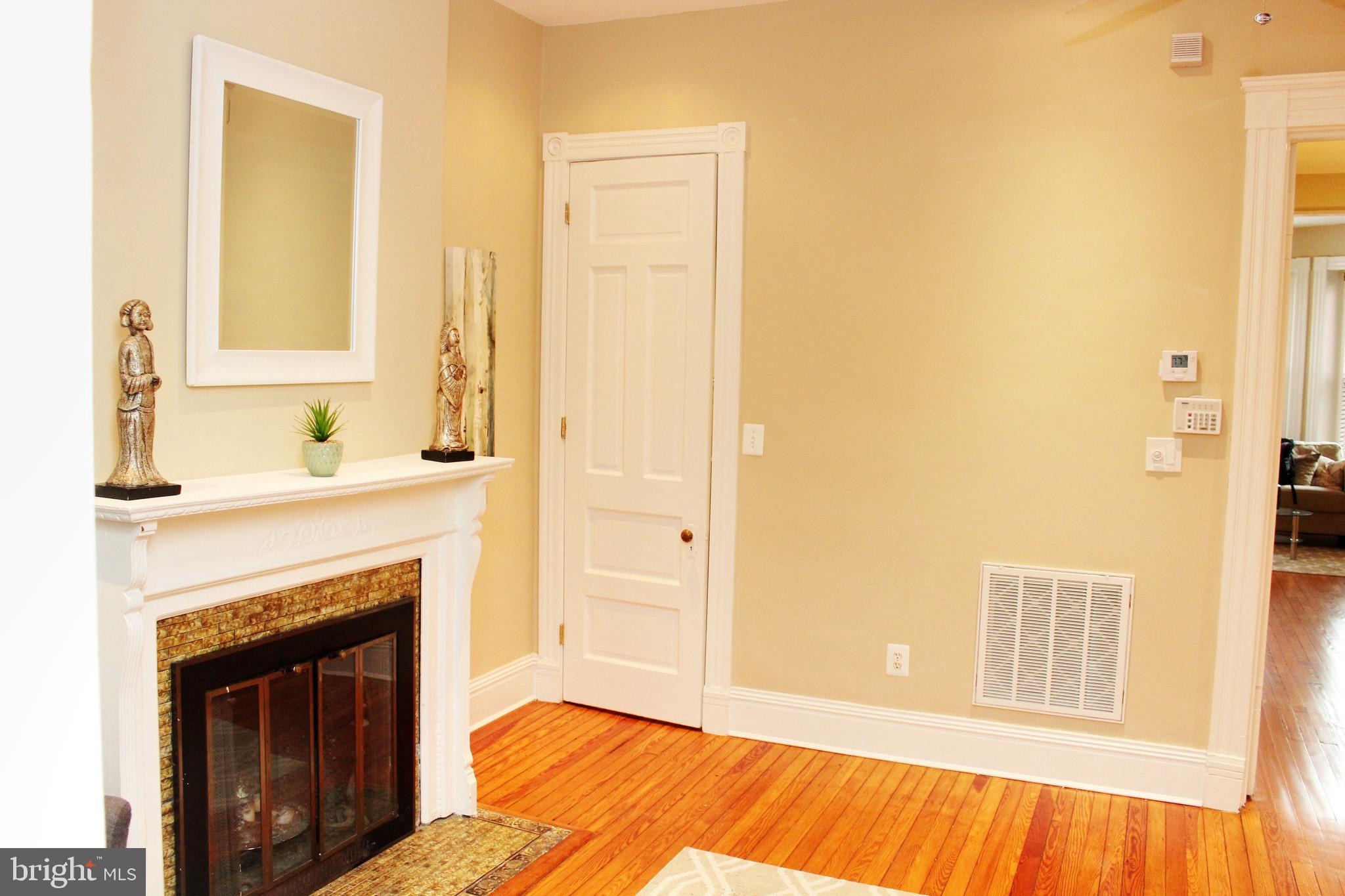 1731 Riggs Place Northwest, Unit 2 Washington, DC 20009 - Photo 8 of 24 a bedroom with a bed and a fireplace