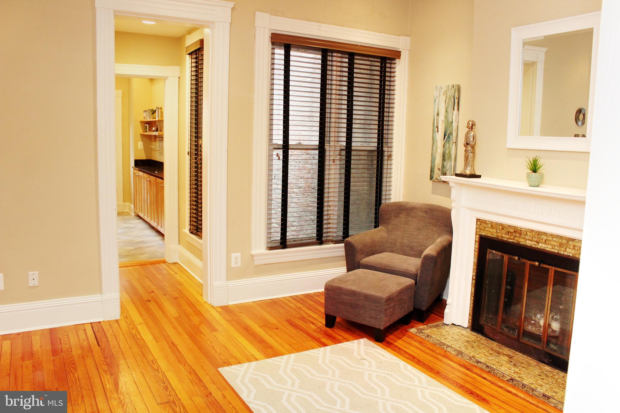 1731 Riggs Place Northwest, Unit 2 Washington, DC 20009 - Photo 9 of 24 a bedroom with furniture and a fireplace