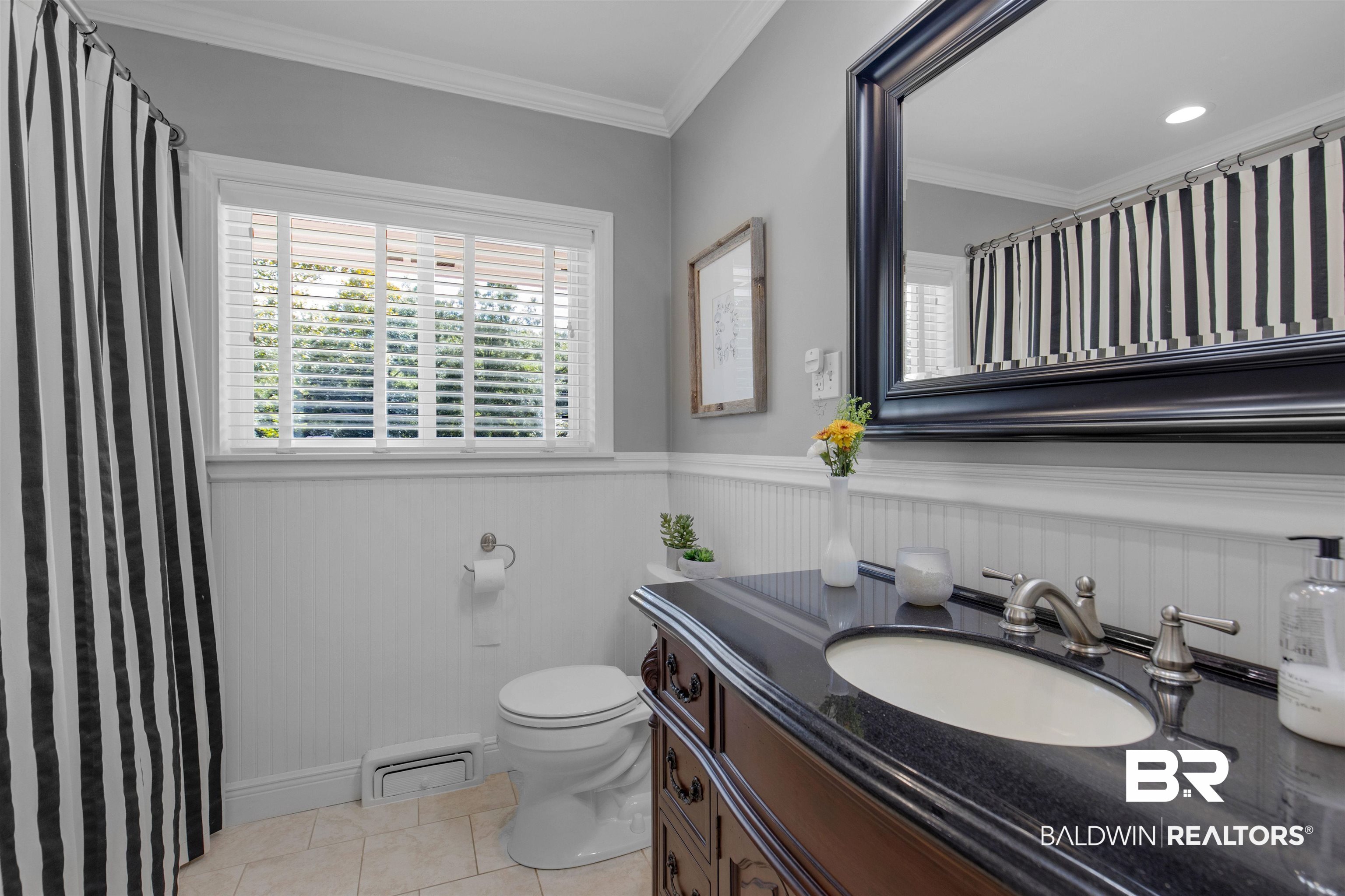 4306 Michael Boulevard Mobile, AL 36609 - Photo 19 of 35 Bathroom featuring crown molding, vanity, toilet, and tile patterned floors