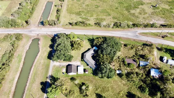 a view of a patio with table and chairs with wooden floor and fence