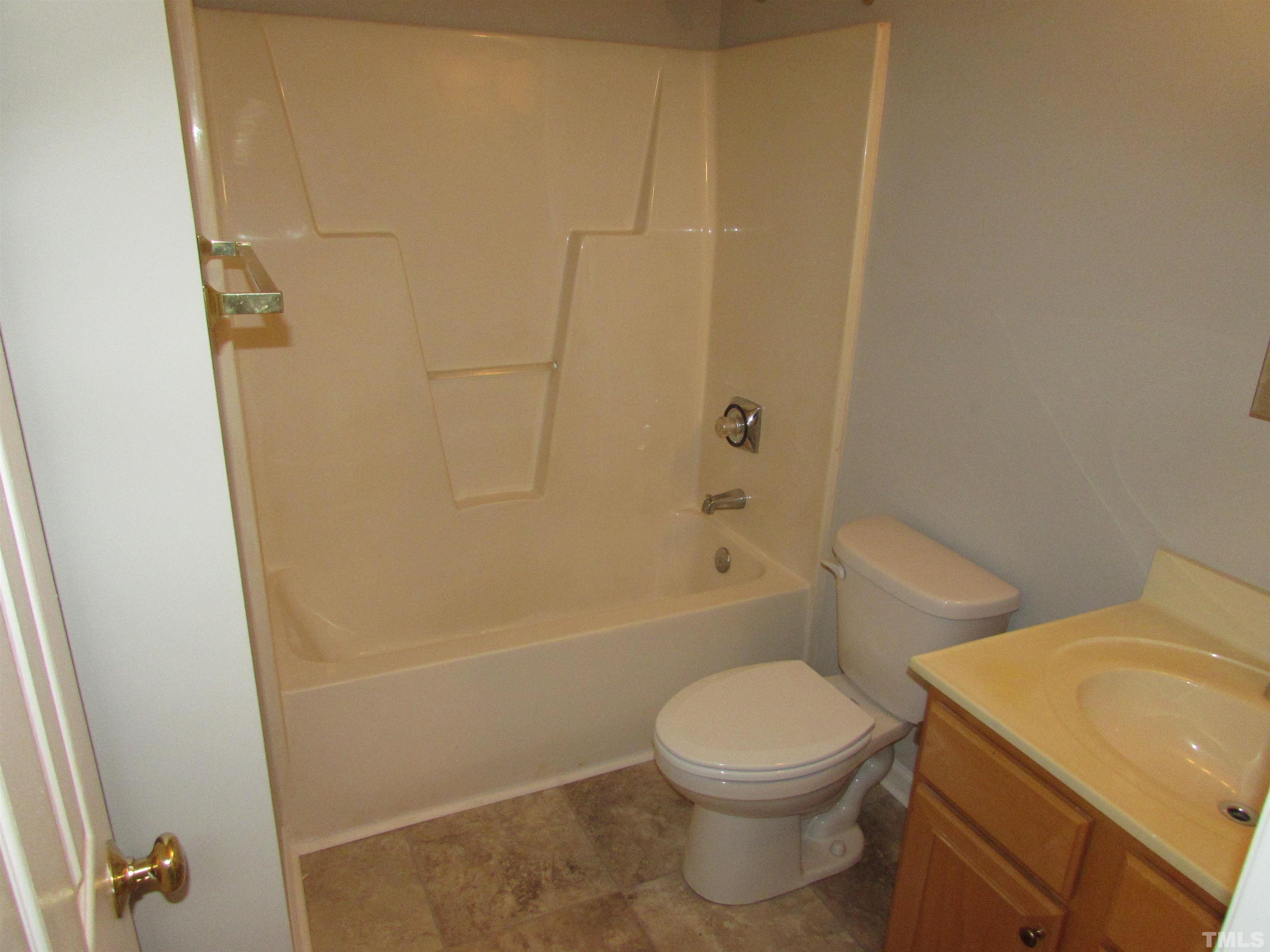 802 Rothshire Court Raleigh, NC 27615 - Photo 20 of 29 a white toilet sitting next to a bath tub