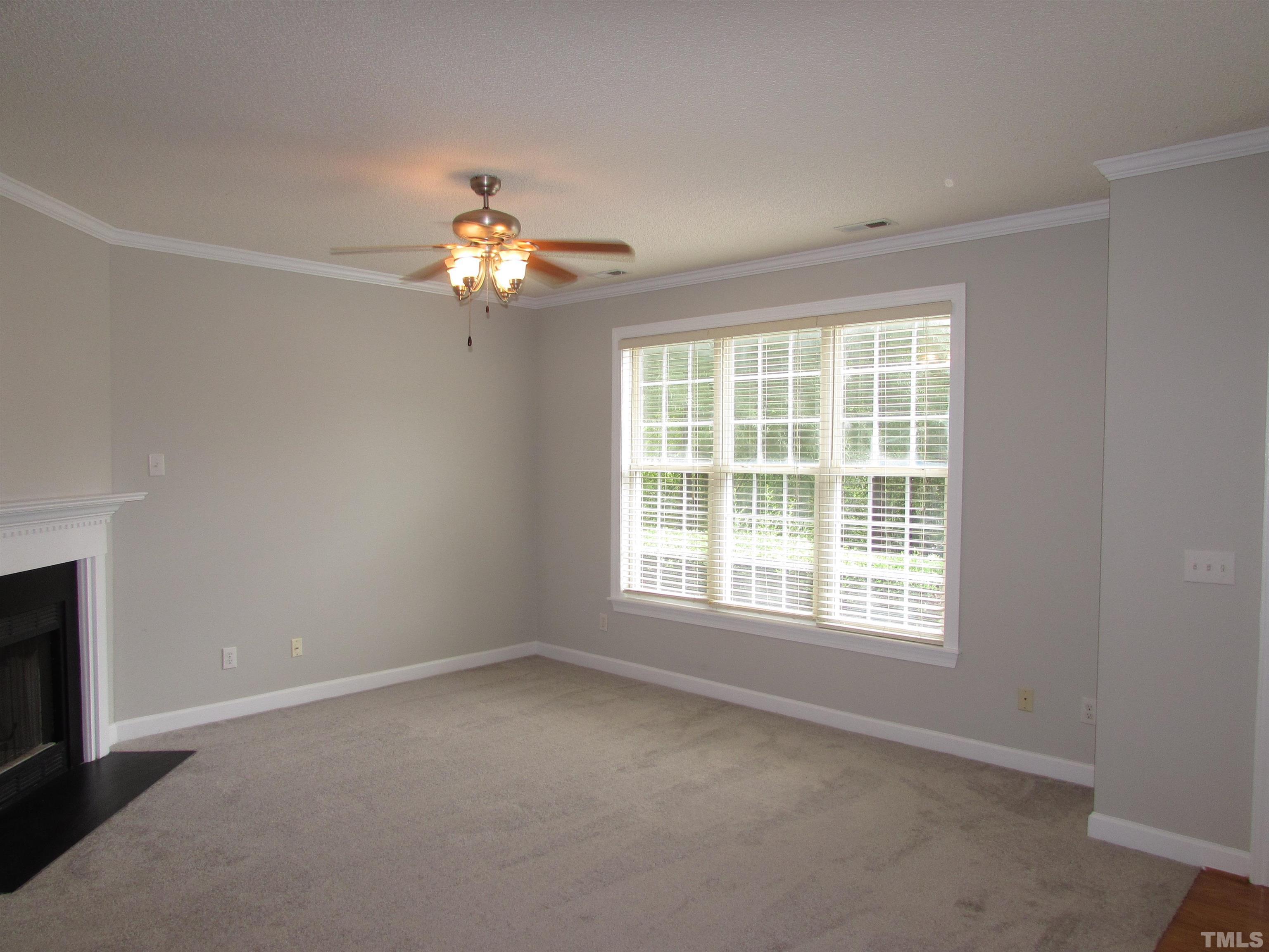 802 Rothshire Court Raleigh, NC 27615 - Photo 4 of 29 an empty room with a window and a fan