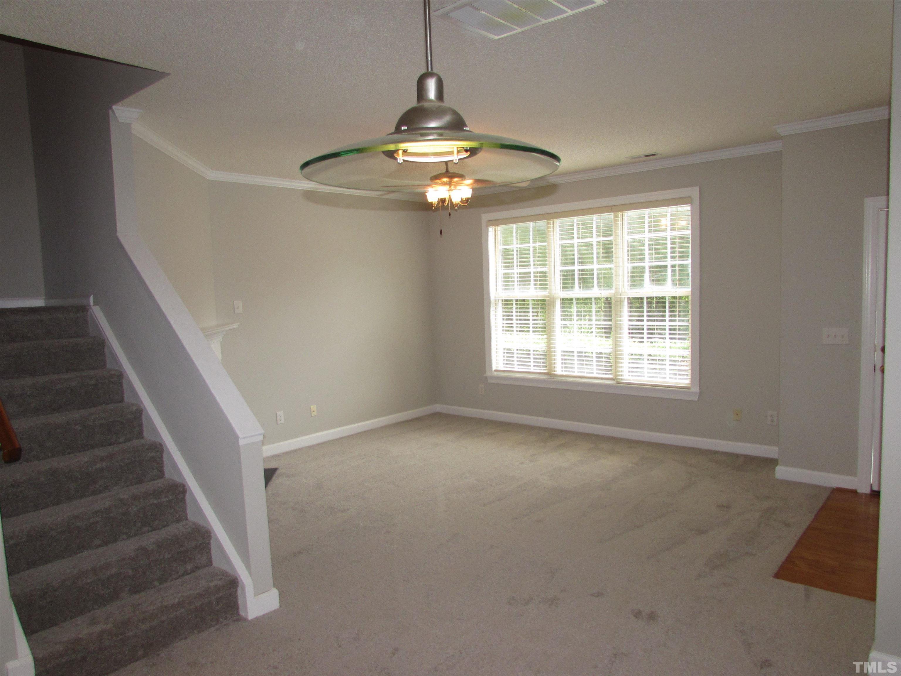 802 Rothshire Court Raleigh, NC 27615 - Photo 6 of 29 a view of an empty room with wooden floor and fan