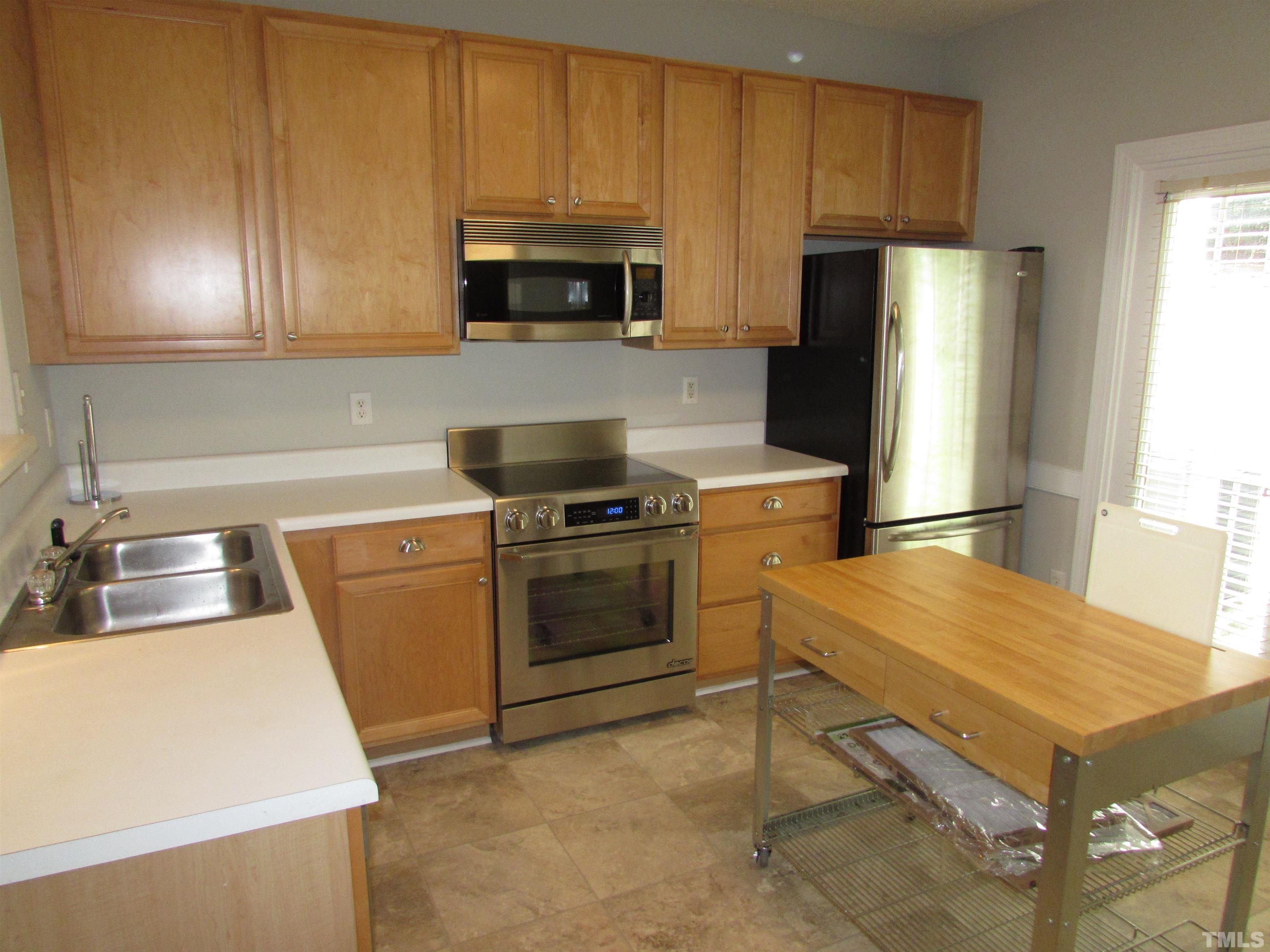802 Rothshire Court Raleigh, NC 27615 - Photo 10 of 29 a kitchen with a sink appliances and cabinets