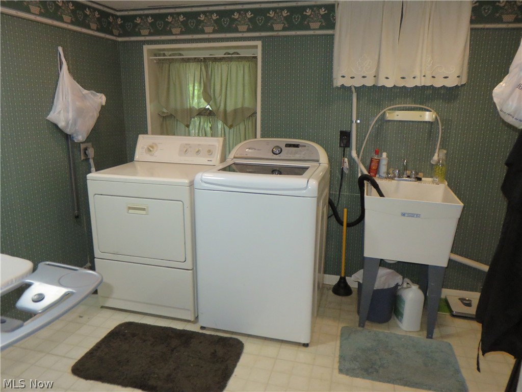 37416 Detroit Road Avon, OH 44011 - Photo 23 of 31 Laundry area featuring light tile patterned flooring, washing machine and dryer, and sink