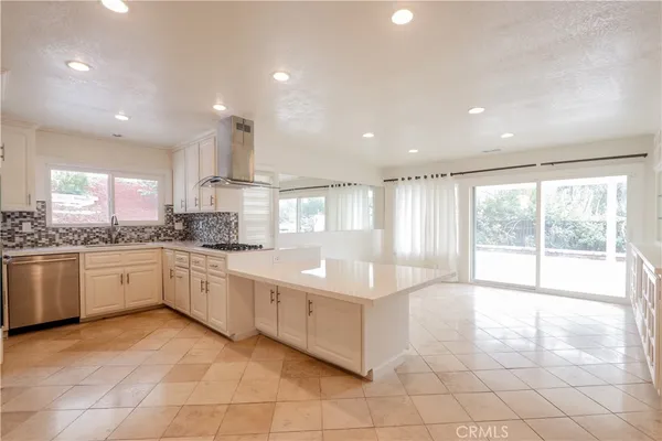 a large white kitchen with a large window