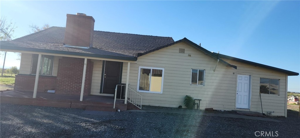 24520 Clark Avenue Orland, CA 95963 - Photo 1 of 13 a front view of a house with a yard
