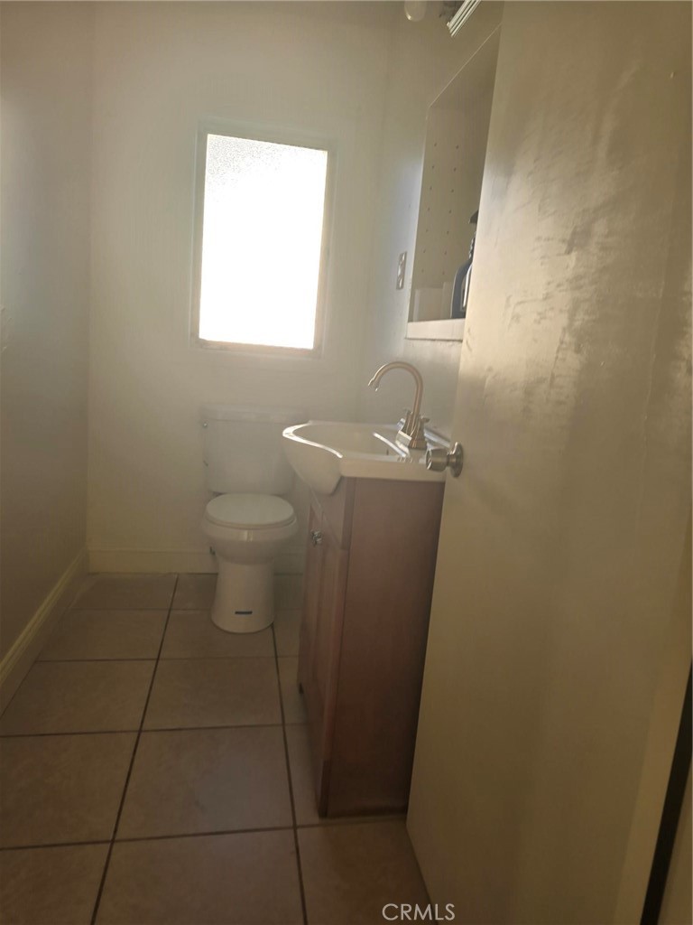 24520 Clark Avenue Orland, CA 95963 - Photo 12 of 13 a bathroom with a sink a toilet and a window