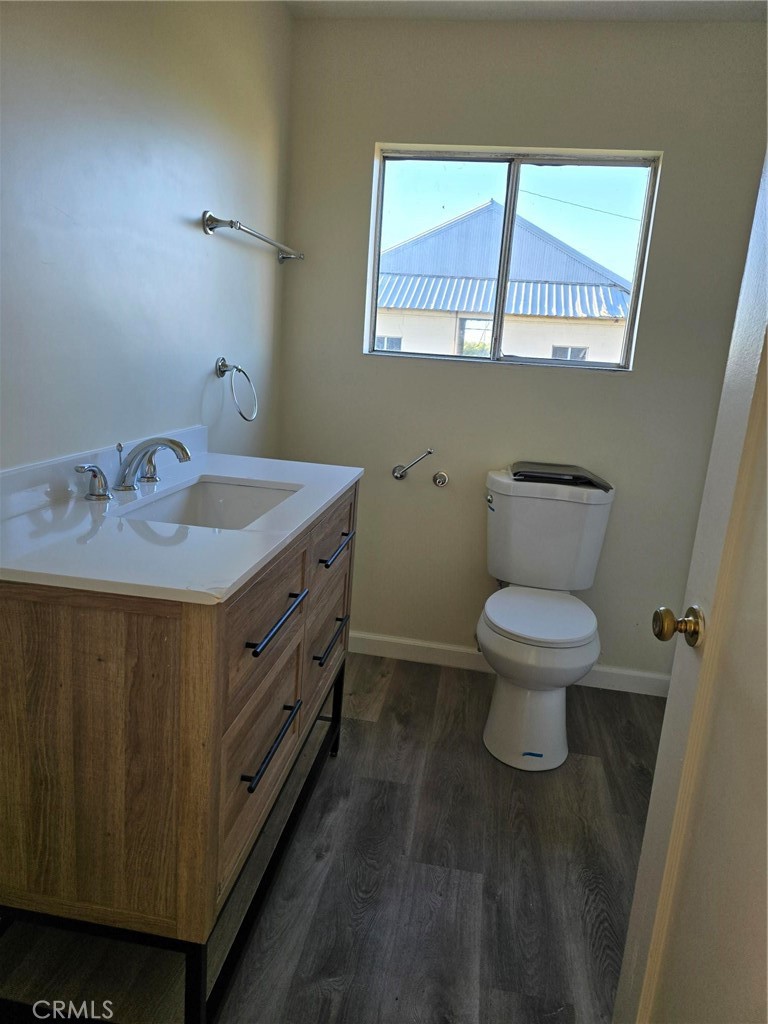 24520 Clark Avenue Orland, CA 95963 - Photo 6 of 13 a bathroom with a granite countertop sink a toilet and a mirror