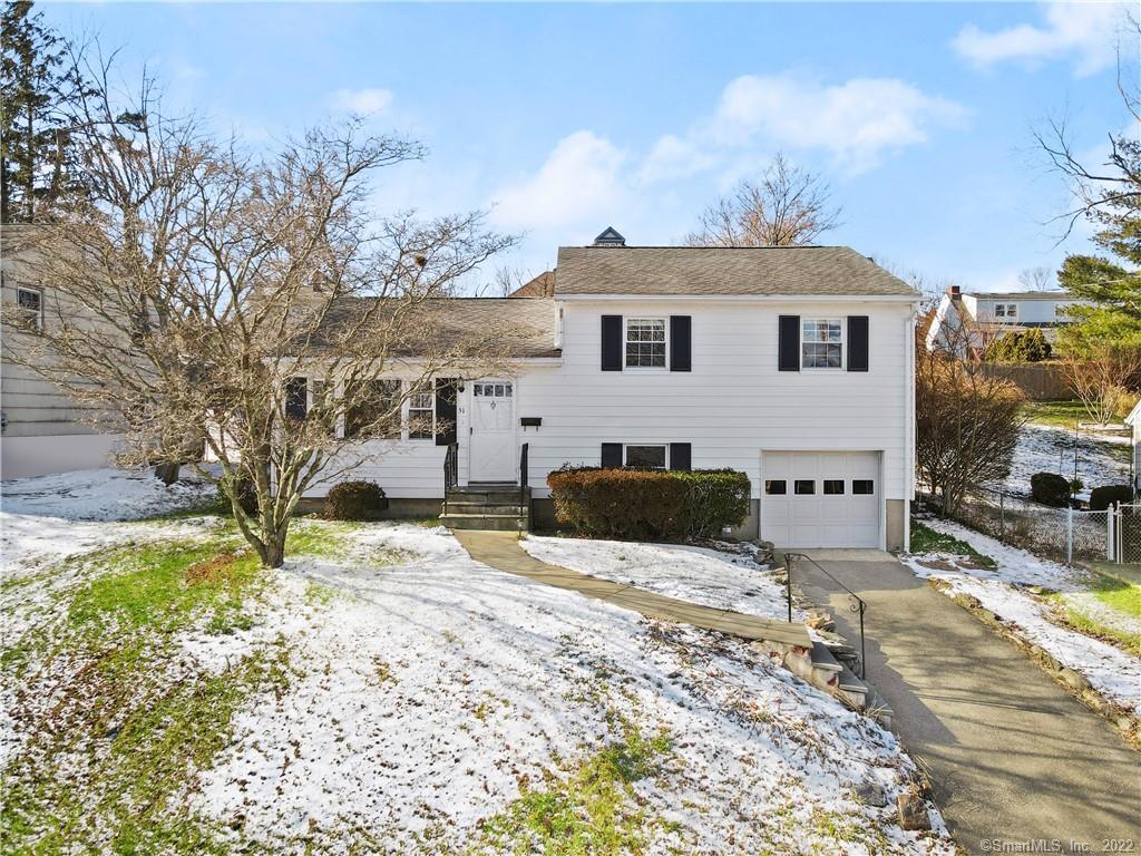 a view of a house with a yard covered in snow
