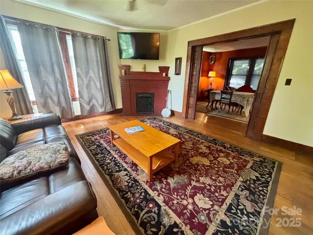 a living room with furniture rug and a fireplace
