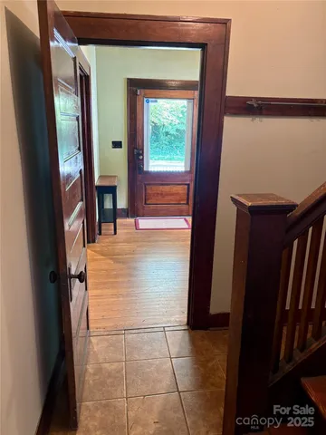 a view of hallway with furniture and a window