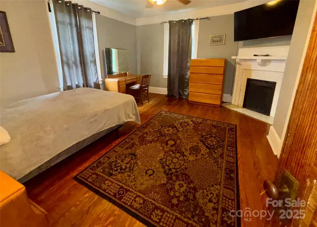 a bedroom with a bed and flat screen tv