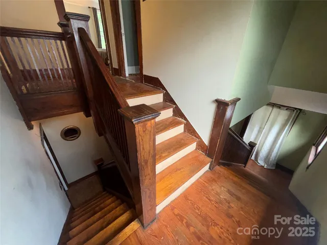 a view of hallway with stairs and a door