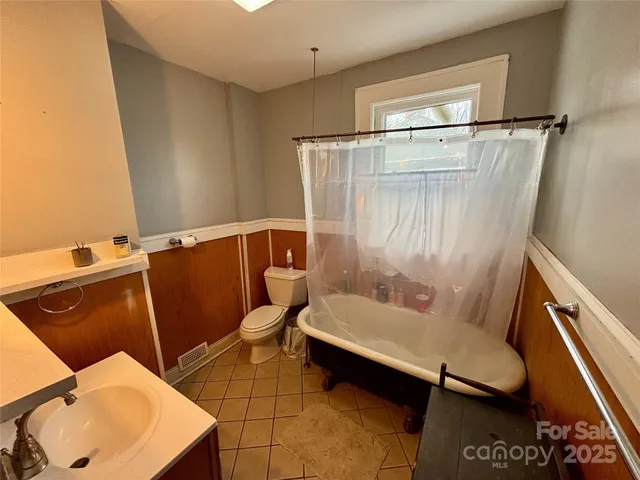 a room with pool table chair and window