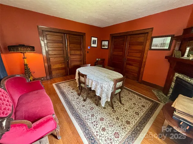 a bedroom with a bed and dresser with mirror