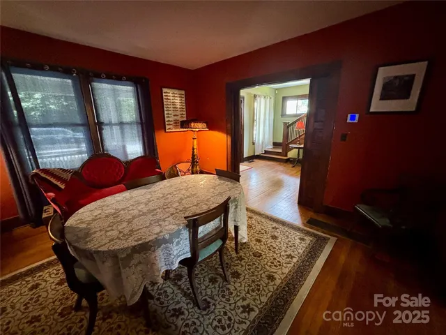a dining room with furniture and window
