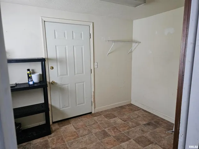 a view of a room with wooden floor and fan