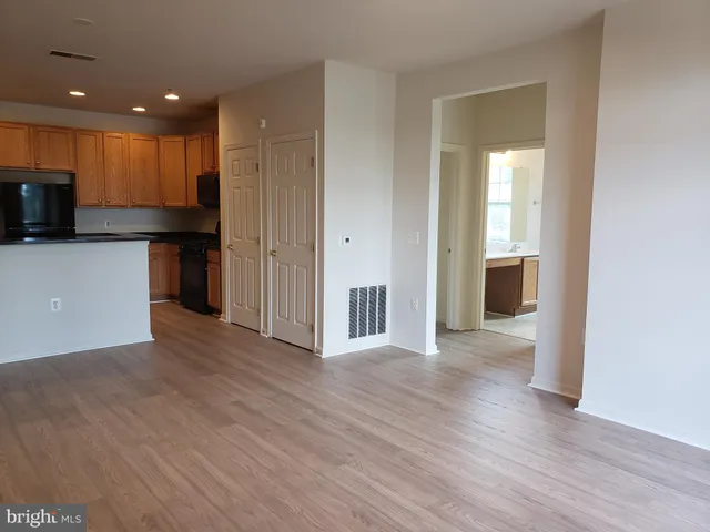 a view of a kitchen with a sink and a refrigerator