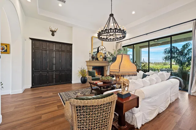 a kitchen with white cabinets and window