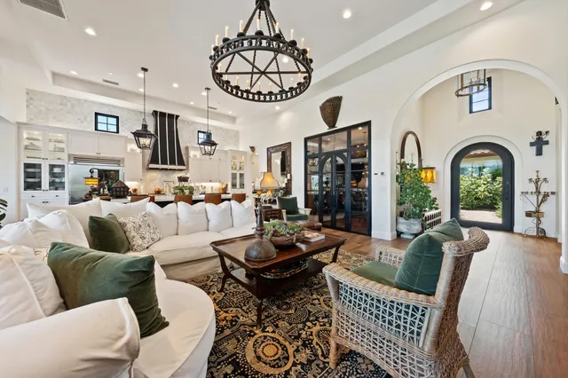 a view of a dining room with furniture wooden floor and chandelier