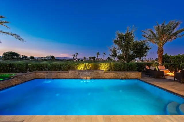 a view of a house with backyard porch and sitting area
