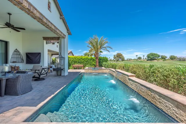 a view of a swimming pool with a yard