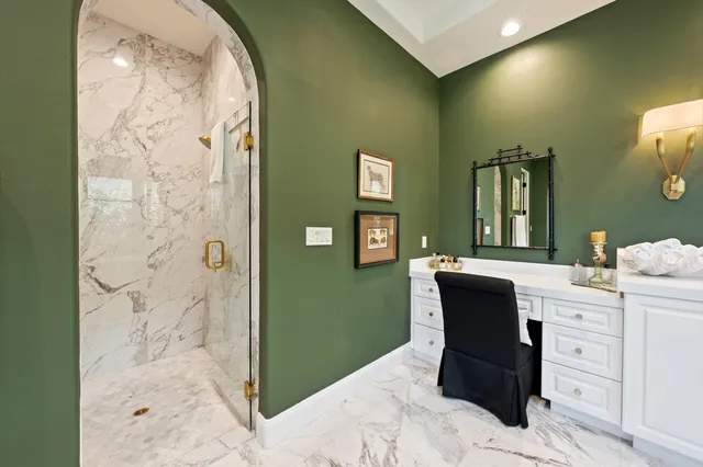 a bedroom with a bed and a lamp on dresser