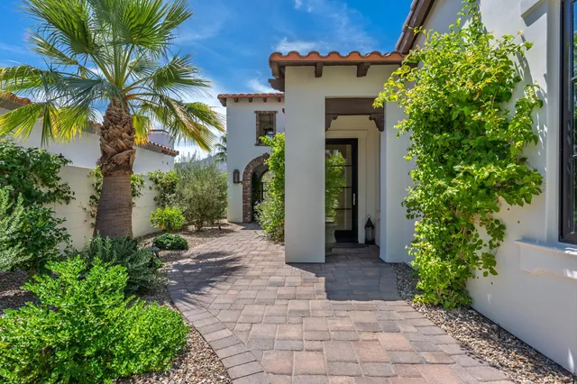 a view of a chair and table in the back yard of the house