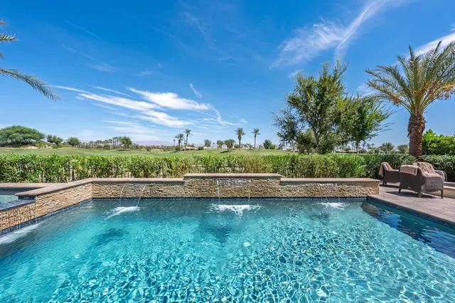 a view of swimming pool with outdoor seating and plants
