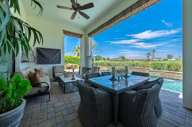 a view of a chairs and table in patio with a lake view
