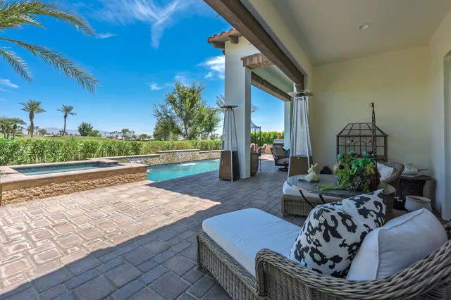a front view of a house with a yard table and chairs