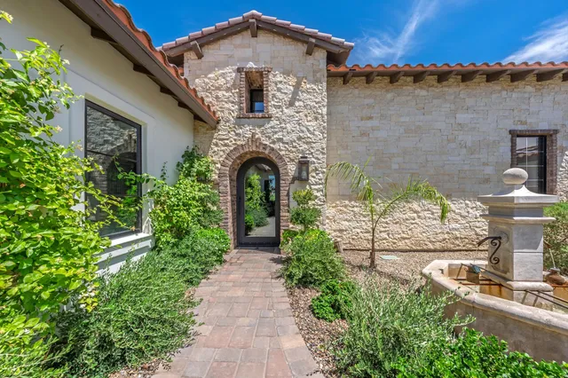 a living room with furniture a fireplace and a chandelier
