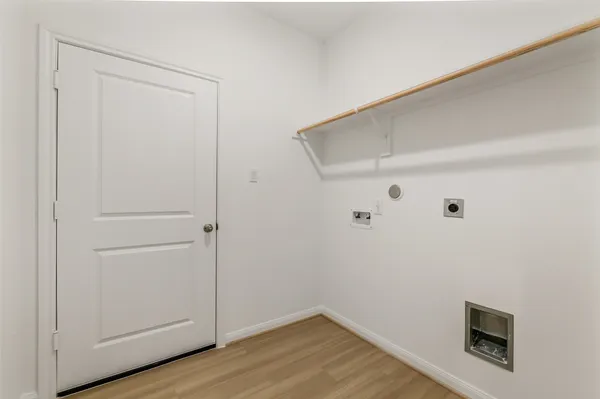 a view of a room with wooden floor