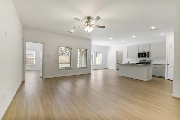 a view of kitchen with closet and wooden floor