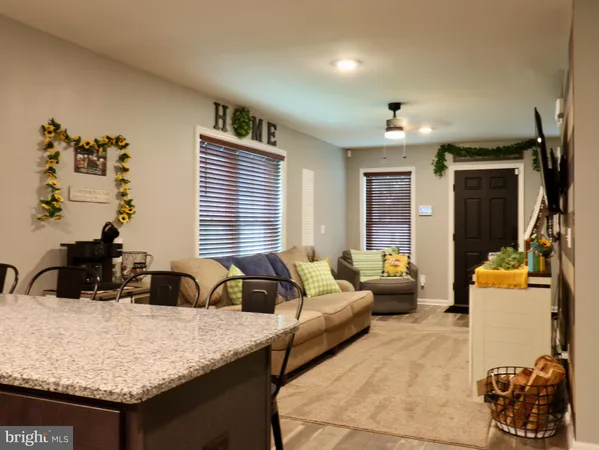a large kitchen with kitchen island a sink stainless steel appliances and cabinets