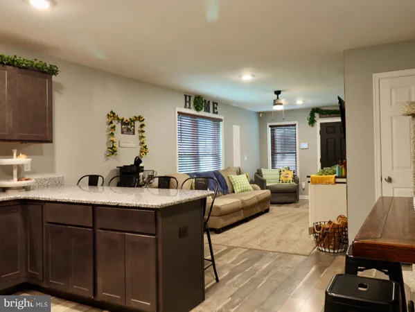 a kitchen with granite countertop stainless steel appliances window a sink and cabinets