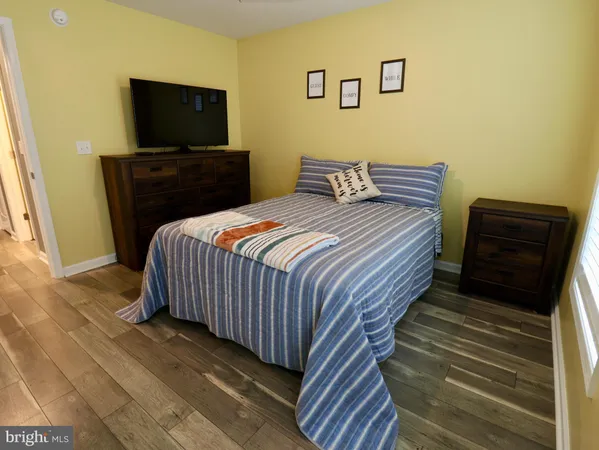 a bedroom with a bed and a dresser