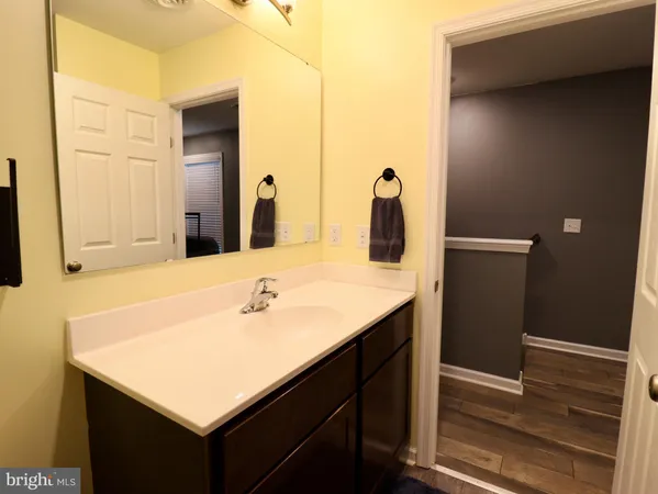 a view of a hallway with wooden floor and a door