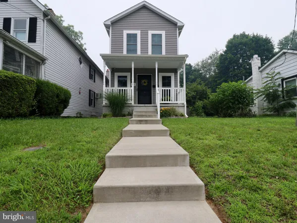 a view of a house with a yard and trees