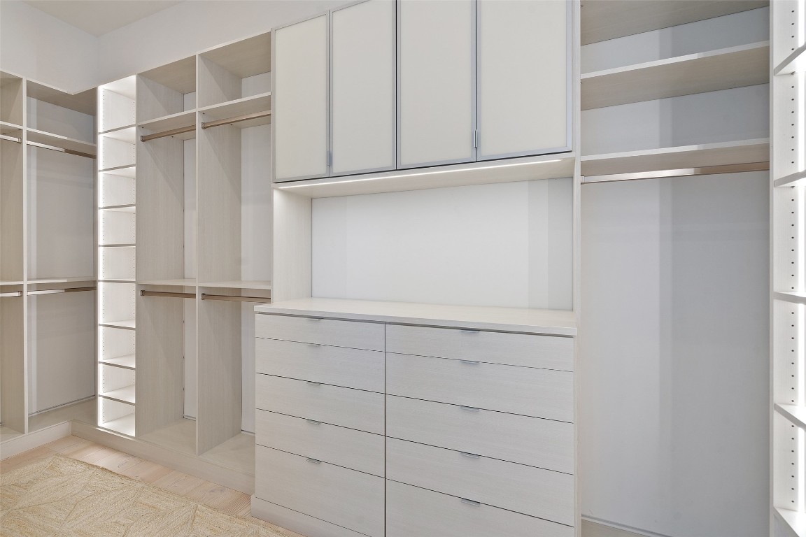 2605 Rockingham Drive Austin, TX 78704 - Photo 19 of 32 Primary closet custom designed by Inspired Closets with under cabinet lighting