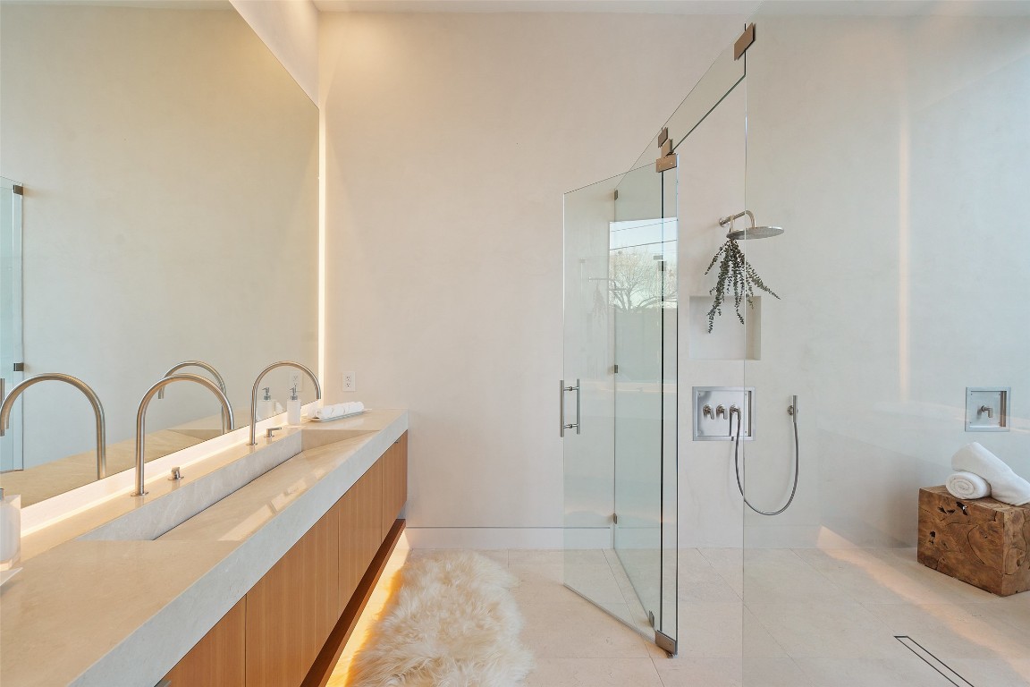 2605 Rockingham Drive Austin, TX 78704 - Photo 20 of 32 Primary bathroom featuring dual sinks, under cabinet lighting and walk-in shower