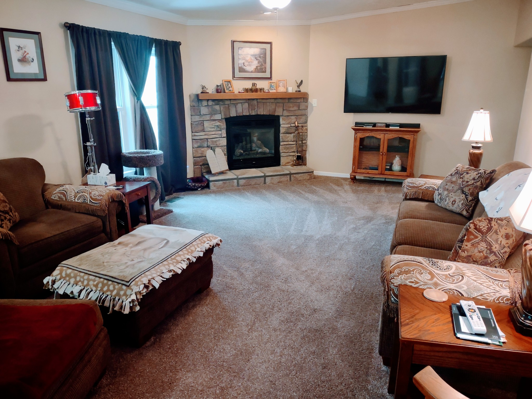 6841 Bethel Road Goodlettsville, TN 37072 - Photo 11 of 27 a living room with furniture a flat screen tv and a fireplace