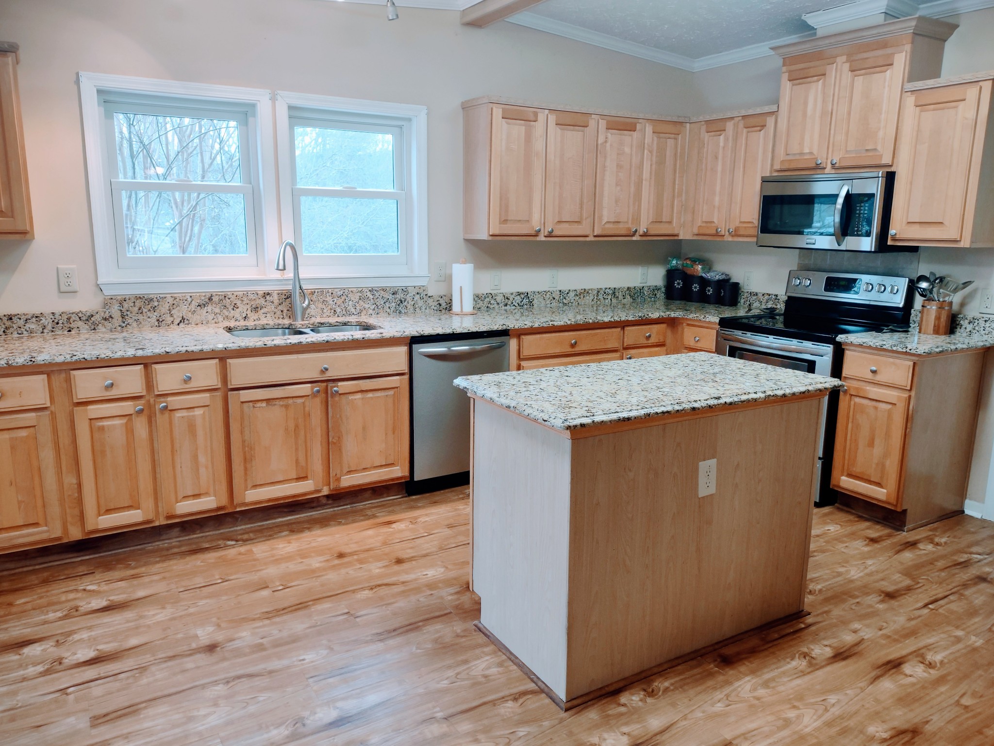 6841 Bethel Road Goodlettsville, TN 37072 - Photo 17 of 27 a kitchen with wooden cabinets a sink and a stove