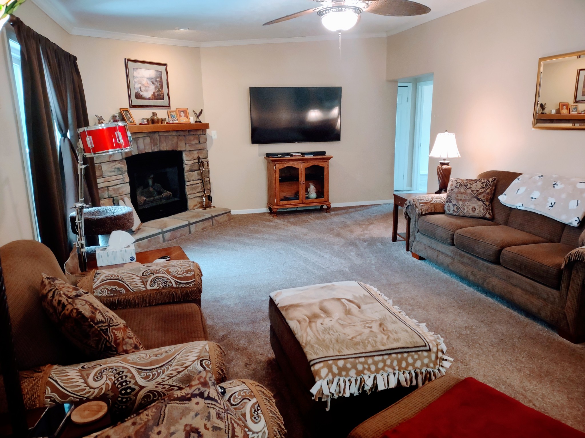 6841 Bethel Road Goodlettsville, TN 37072 - Photo 9 of 27 a living room with furniture a flat screen tv and a fireplace