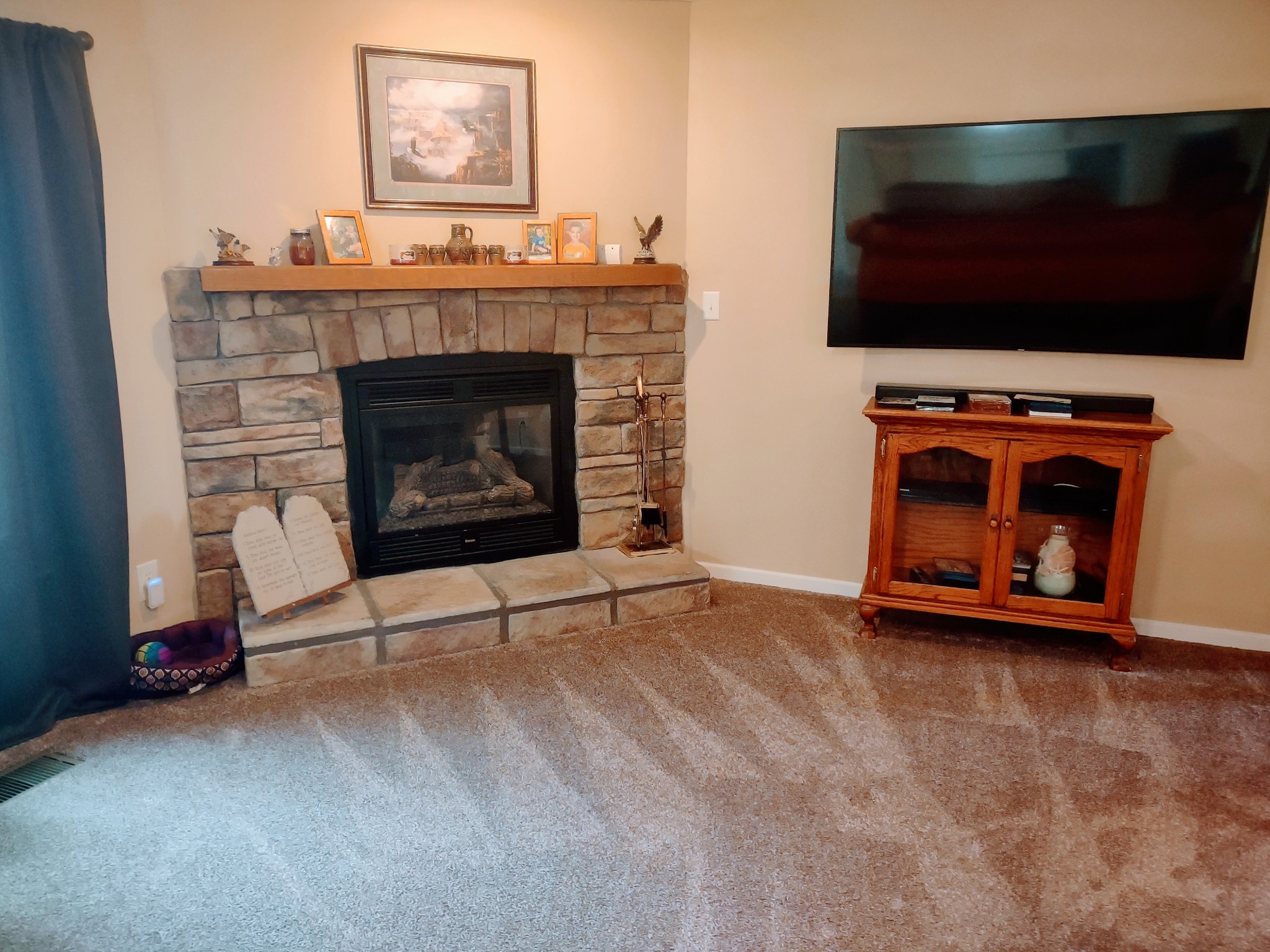 6841 Bethel Road Goodlettsville, TN 37072 - Photo 10 of 27 a living room with a fireplace and a flat screen tv
