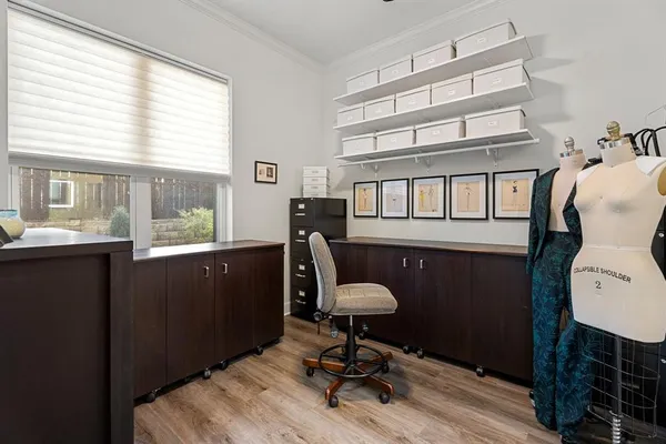 a room with wooden floor and windows