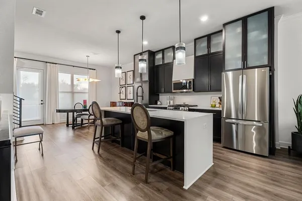 a kitchen with granite countertop stainless steel appliances lots of counter space and a sink