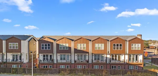 a front view of a residential apartment building with a yard